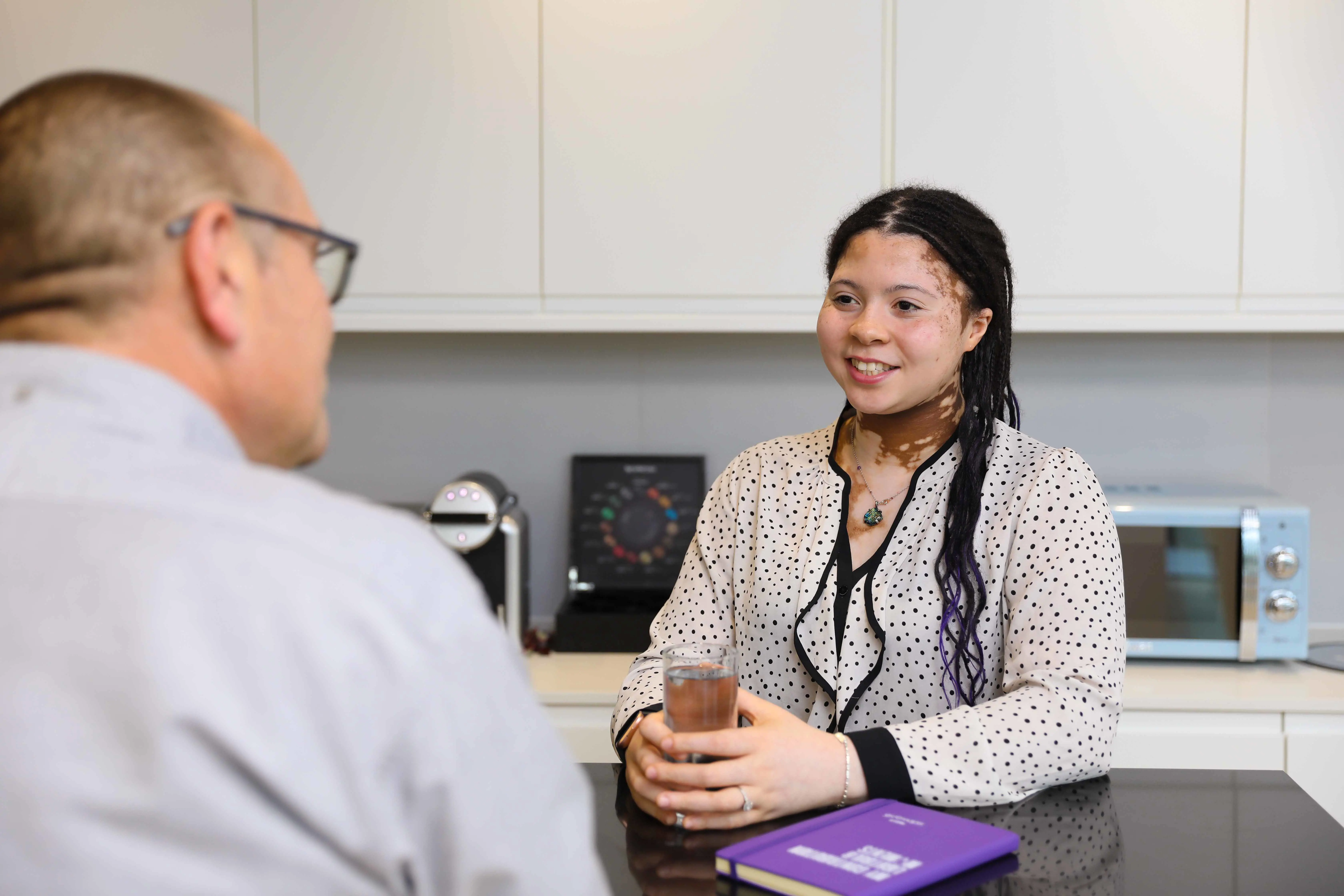 Two office workers discussing assignments