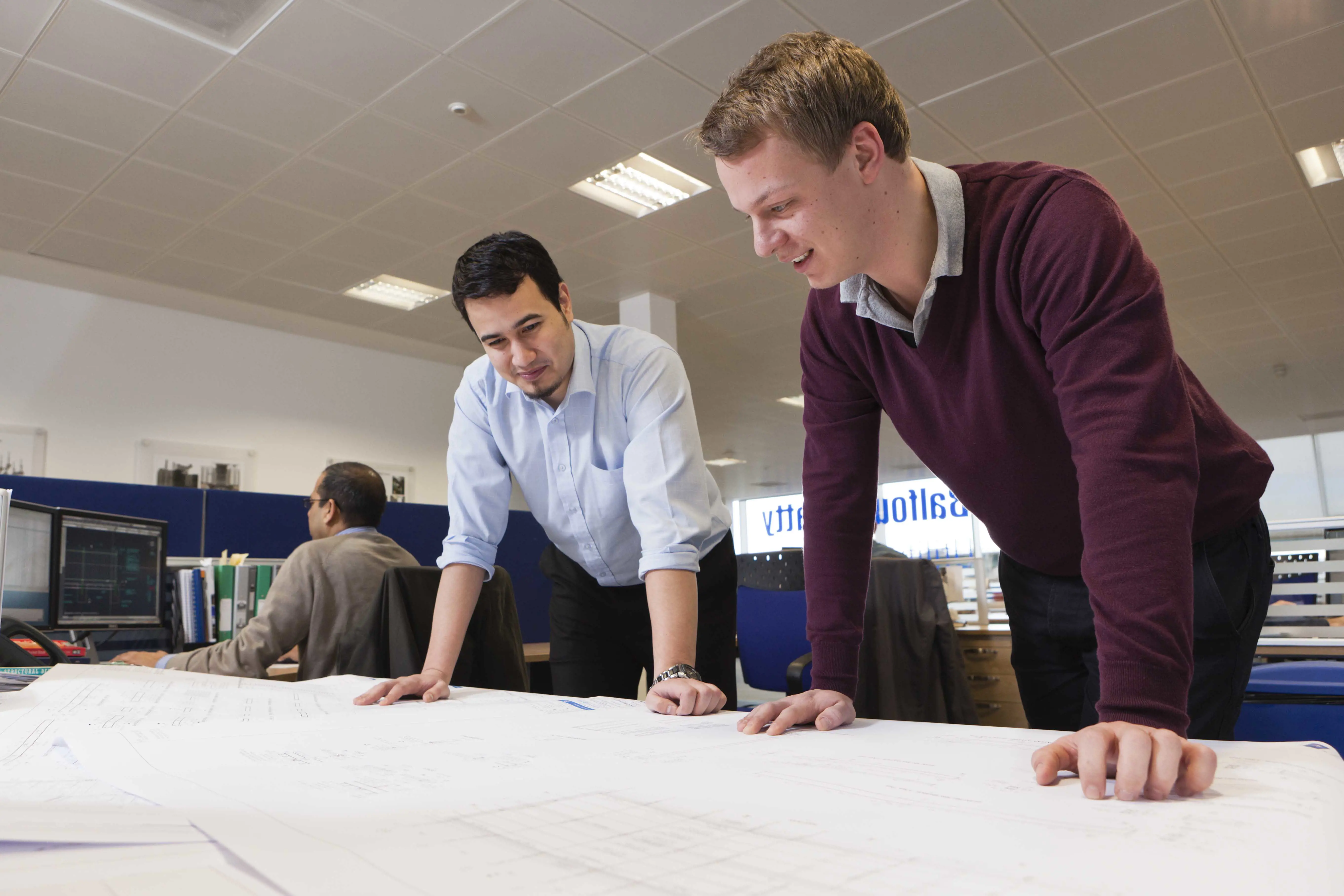 Two colleagues looking over project plans